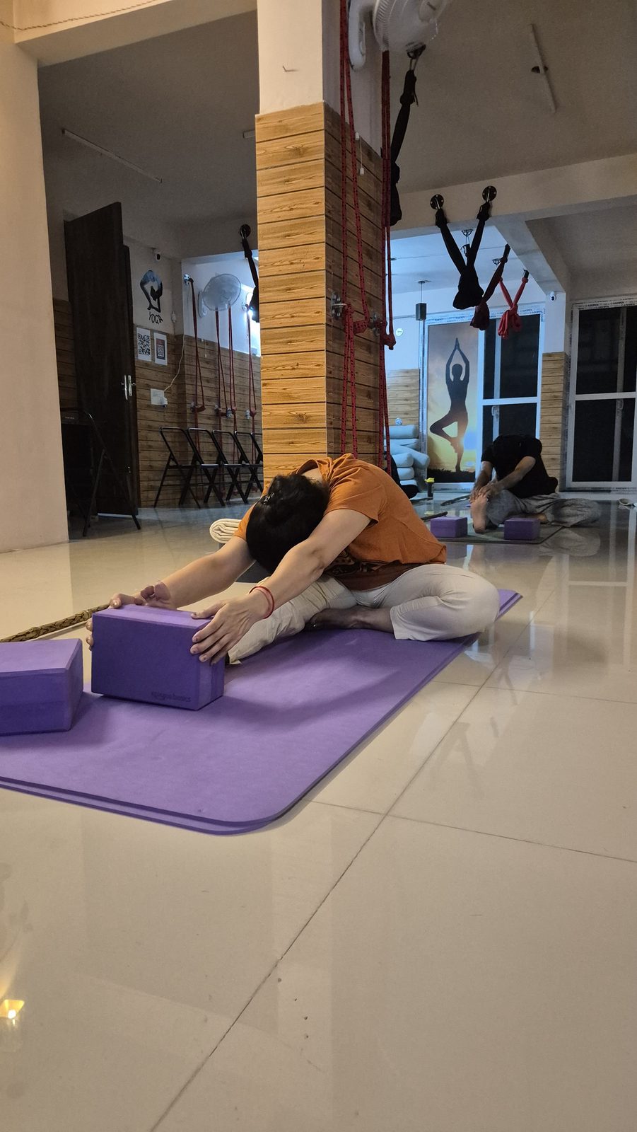Student in a seated head-to-knee forward fold